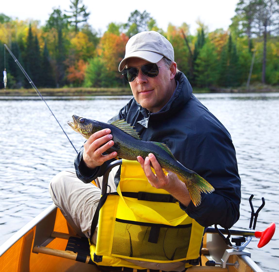 happy-fisherman-holds-up-a-walleye-on-a-northern-m-DN2SM64-resize.jpg